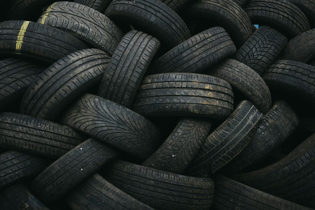 Full Frame Close Up Of Tyres From Scrapped Cars In Vehicle Recycling Centre